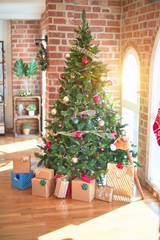 Nice christmas tree with ornaments and gifts at home