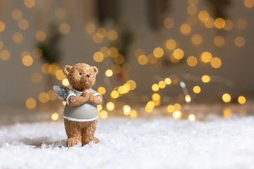 Decorative figurines of a Christmas theme. Figurine of a cute bear with angel wings. Festive decor,...