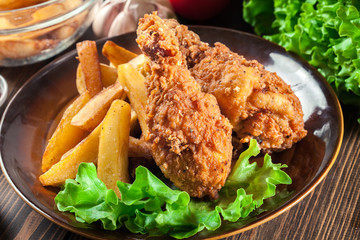 Crispy fried kentucky chicken legs with french fries