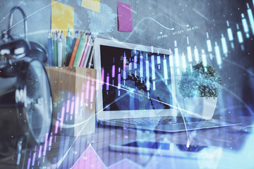 Forex market graph hologram and personal computer on background. Double exposure. Concept of investment.