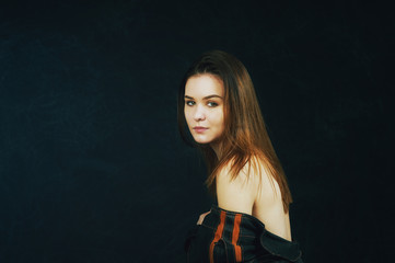 Studio portrait of a young beautiful woman on a dark background