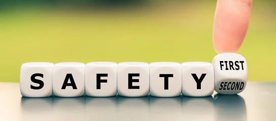 Fotobehang Hand turns a dice and changes the expression "safety second" to "safety first" © Fokussiert