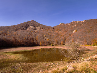 Lake Squincio in autumn in the Parco dei Cento Laghi ie Park of One Hundred Lakes, in the Apennine mountains National Park, Italy.