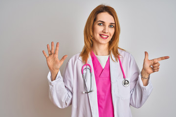 Redhead caucasian doctor woman wearing pink stethoscope over isolated background showing and pointing up with fingers number seven while smiling confident and happy.