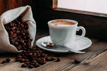 coffee Cup with beans on wooden background