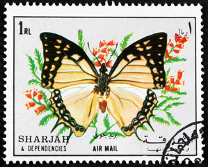 Fototapeta na wymiar Postage stamp from Sharjah, with an image of a butterfly