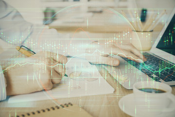 Multi exposure of stock market graph with man working on laptop on background. Concept of financial analysis.