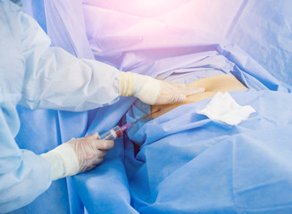 Arthroscope surgery. Orthopedic surgeons in teamwork in the operating room with modern arthroscopic...