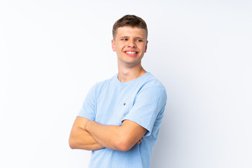 Young handsome man over isolated white background with arms crossed and happy
