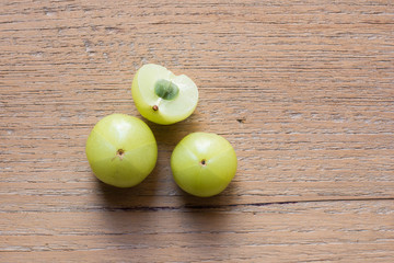Amla green fruits ,Phyllanthus emblica on wood background.