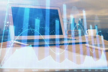 Stock market graph and table with computer background. Double exposure. Concept of financial analysis.