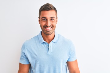 Young handsome elegant man wearing blue t-shirt over isolated background with a happy and cool smile on face. Lucky person.