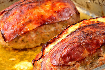Close-up of tasty baked pork meatloaf in pan.