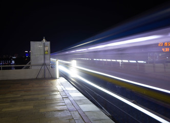 Colorful Underground Subway Train with motion blur and a clock