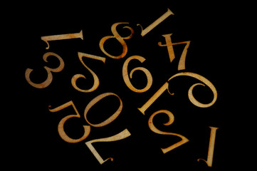 Wooden figures on black background close up