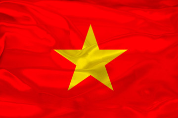 beautiful photo of the colored national flag of the modern state of Vietnam on a textured fabric, concept of tourism, emigration, economy and politics, closeup