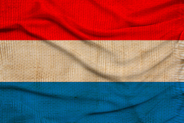 beautiful photo of the colored national flag of the modern state of Luxembourg on textured fabric, concept of tourism, emigration, economy and politics, close up