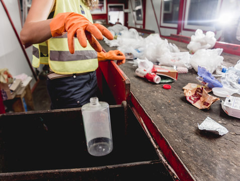 At modern recycling plant. Separate garbage collection. Workers sorting trash to be processed. Trash sorting.
