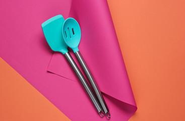 Kitchen tools on a colored paper background. Minimalistic cooking still life. Pastel color trend