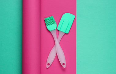 Kitchen tools on a colored wrapped paper background. Minimalistic cooking still life. Pastel color trend