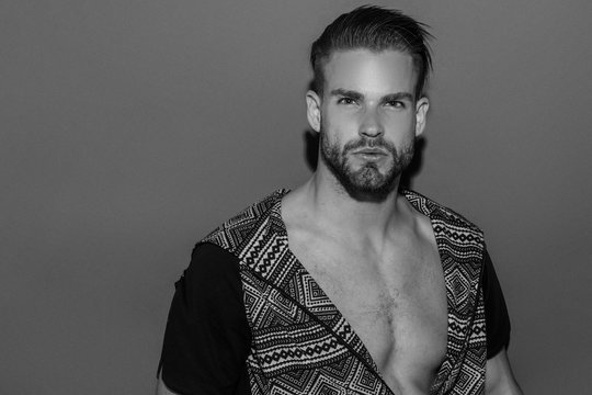 Black and White Muscle strong beautiful stripped male model in casual cloath on black isolated font background