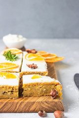 Raw carrot cake with cream cheese frosting, dried orange slices and spices (cinnamon and anise). Healthy food. 