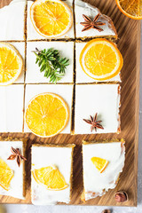 Raw carrot cake with cream cheese frosting, dried orange slices and spices (cinnamon and anise). Healthy food. 