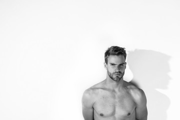 Fototapeta premium Black and White Muscle strong beautiful stripped male model in denim jeans on white isolated font background with shadows