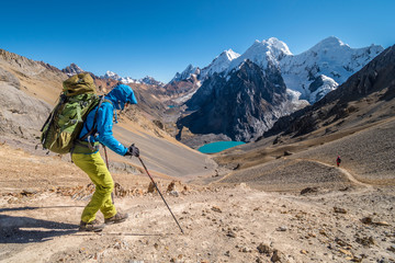 Girl hiking Huayhuash circuit, Santa Rosa pass with epic view to Siula Grande peak, Huayhuash...