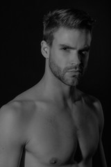 Naklejka premium Black and White Strong stripped muscle male model in black underwear on black isolated font background