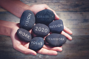 Unknown man holding pebbles of success future