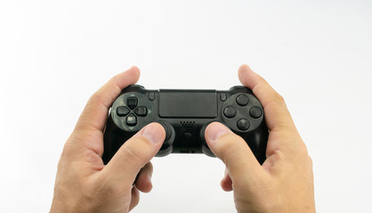 Hands of caucasian man with wireless game console controller or joystick with buttons in black color on white background