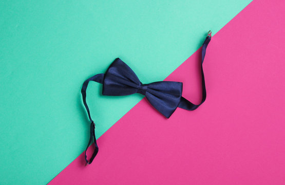 Bow Tie On Colored Paper Background. Top View.