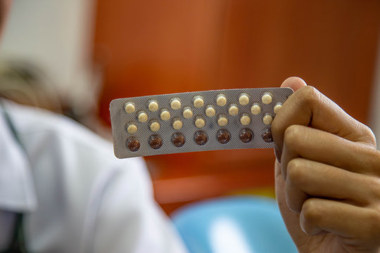 doctor woman holding contraceptive pills in the room Health and medical Gynecology hormone concept