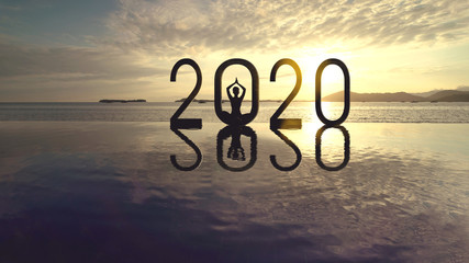 Young woman meditating with number 2020