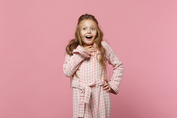 Little cute one kid girl 4-5 years old wearing rose clothes isolated on bright pink wall background, children studio portrait. People sincere emotions, childhood lifestyle concept. Mock up copy space.
