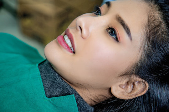 Dentist examining mouth teeth of beautiful young Asian woman in hospital clinic dental health care beautify oral hygiene concept