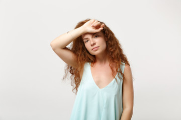 Naklejka premium Young tired redhead woman girl in casual light clothes posing isolated on white background, studio portrait. People sincere emotions lifestyle concept. Mock up copy space. Putting hand on forehead.