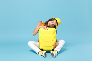 Traveler tourist woman in yellow casual clothes, hat sleep on suitcase photo camera isolated on...