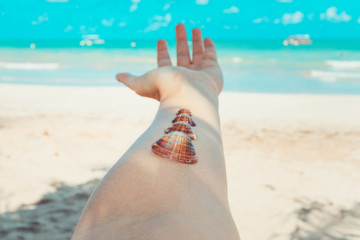 Arm with sea shells laid on it