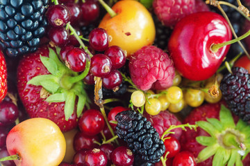 Background of mix berries strawberry, raspberry, blackberry, red and yellow currants, cherries. Healthy Living and Nutritious Food concept, close up