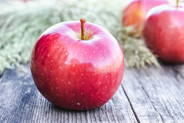 Ripe red apple lies on a wooden table. Vitamins and a healthy diet. Vegetarian concept.