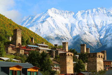 Stunning View of Medieval Svan Tower-houses against the Snow-capped Caucasus Mountain in Mestia, Svaneti Region of Georgia - obrazy, fototapety, plakaty