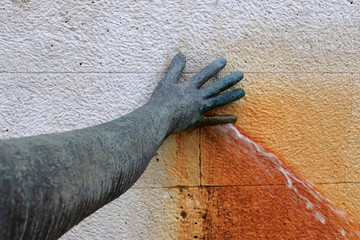 Hand plugging a water leak