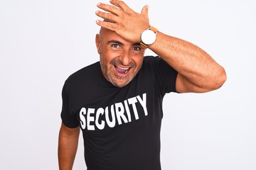Middle age safeguard man wearing security uniform standing over isolated white background surprised...