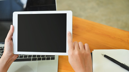 Top view woman hand's holding white table on office table.