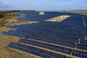 Aerial view of industrial photostatic solar units panels. Photovoltaic power supply systems. Solar power plant. The source of ecological green renewable energy.