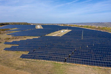 Aerial view of industrial photostatic solar units panels. Photovoltaic power supply systems. Solar power plant. The source of ecological green renewable energy.