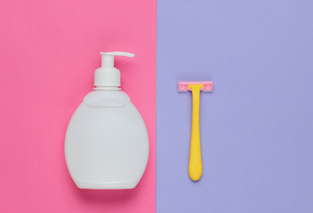 Bottle of gel for depilation, razor on a colored paper background. Pastel color trend. Minimalistic beauty concept. Top view