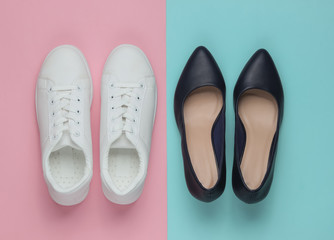 Leather high heel shoes and sneakers on colored pastel background. Minimalistic fashion concept. Top view